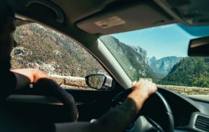 man driving car through the mountains